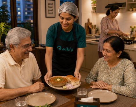A Qwikly chef serving a fresh home-cooked meal to a couple